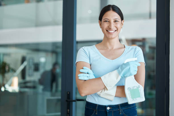 housemaid wearing blue t-shirt and white gloves making smile face.